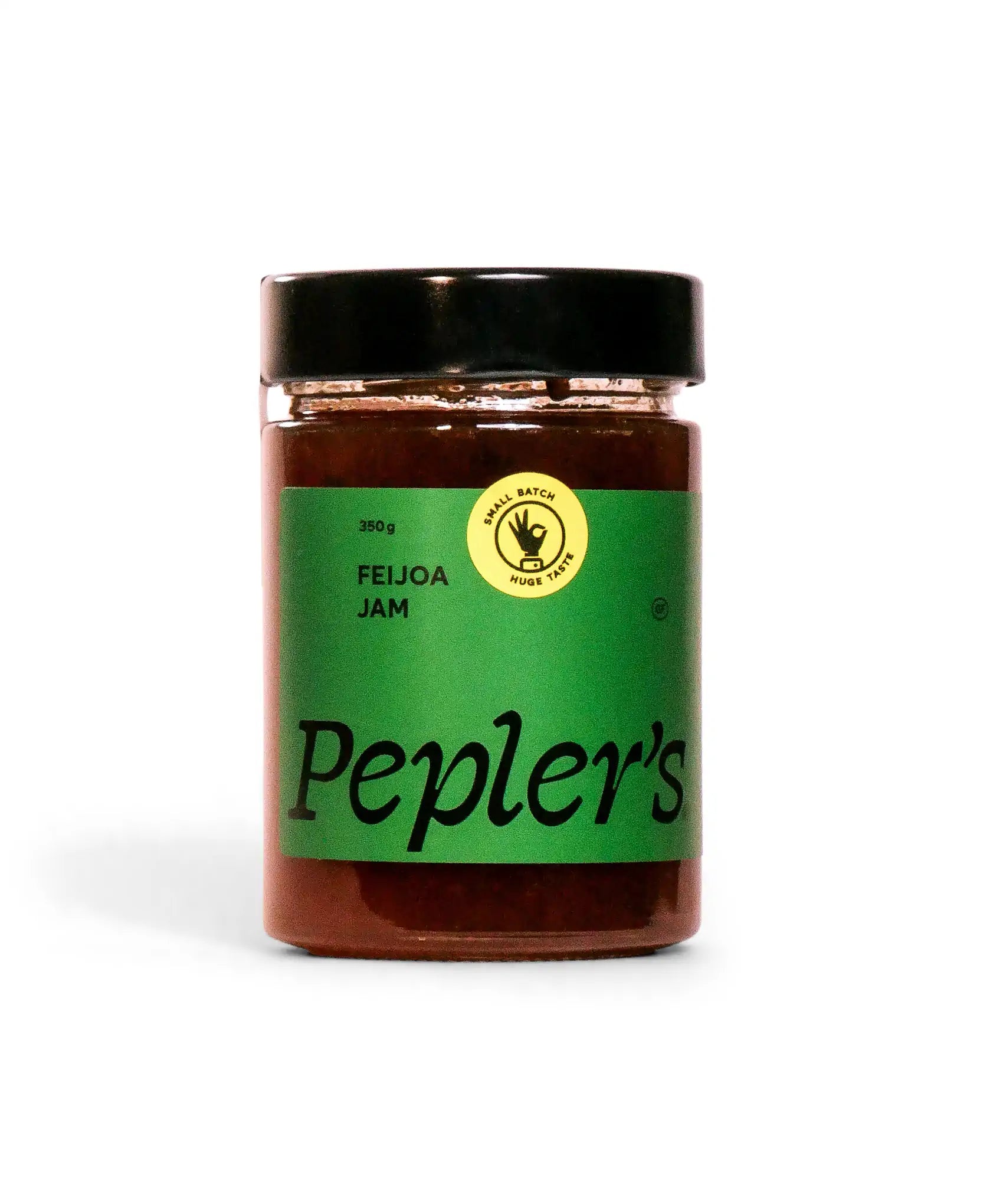 A jar of Pepler's feijoa jam with a black lid and a green label. The label features the words "Pepler's" prominently, along with "FEIJOA JAM" and a small circular logo indicating "SMALL BATCH" and "HUGE TASTE." The jar is filled with a rich, dark jam and is shown against a plain white background, highlighting its design and contents.