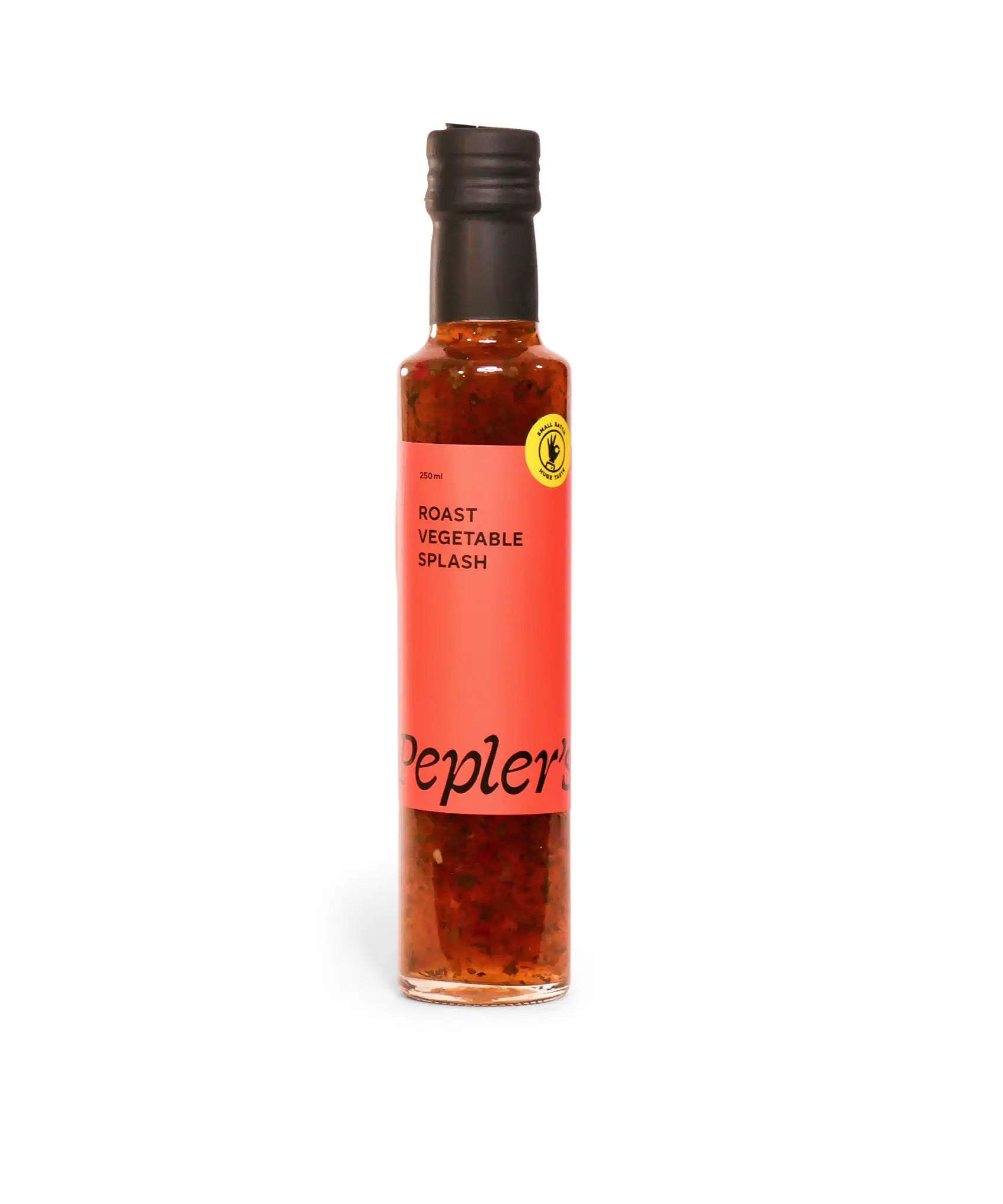A 250 ml glass bottle filled with a colourful roast vegetable dressing, featuring a vibrant pink label that prominently displays the text "Roast Vegetable Splash" and the brand name "Pepler's" in a stylish black font. The bottle has a sleek black cap and a yellow circular emblem indicating that it is made from natural ingredients. The background is plain white, allowing the product to stand out.