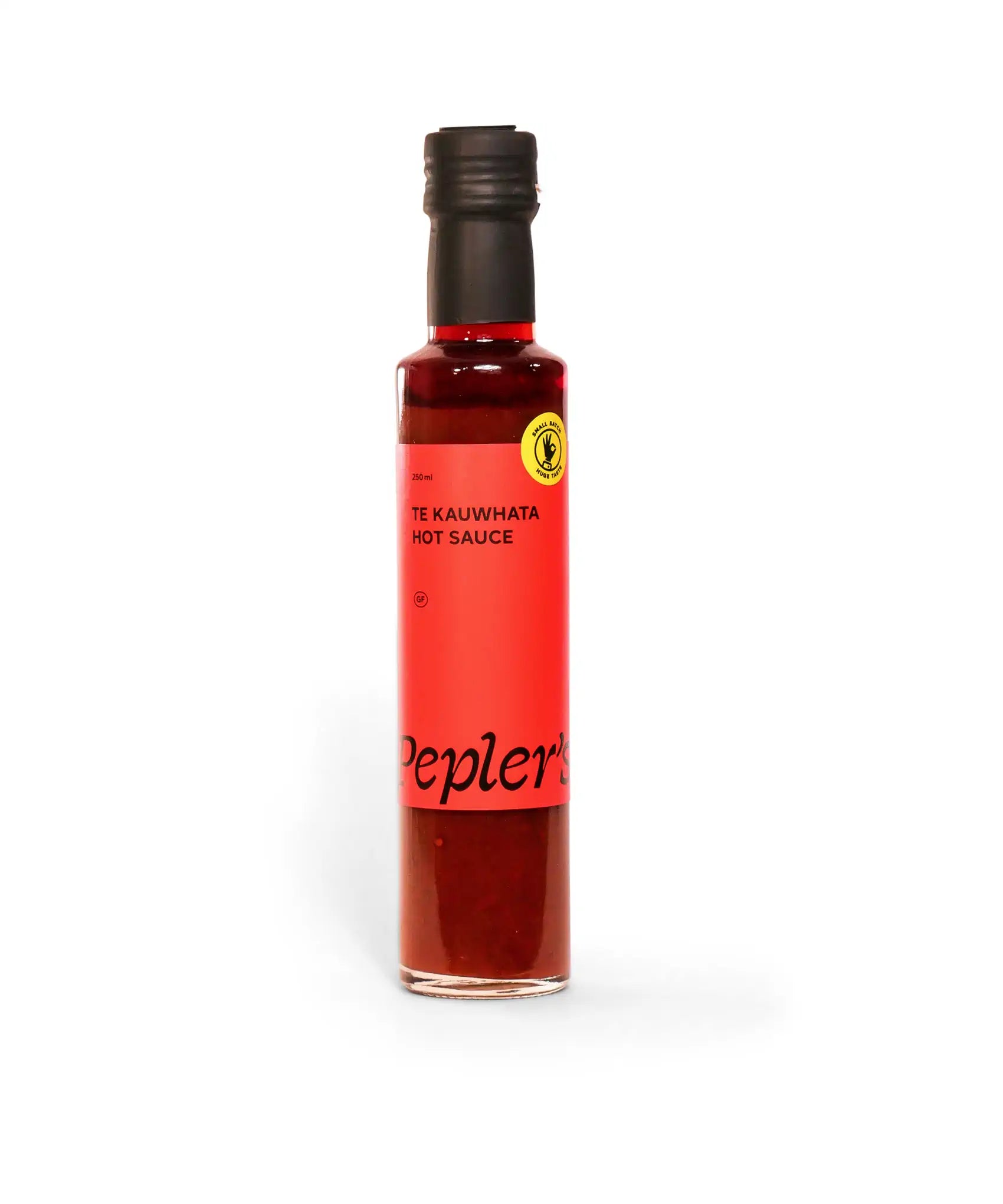 A 250 ml bottle of Te Kauwhata hot sauce, featuring a vibrant red label with the text “Te Kauwhata Hot Sauce” prominently displayed. The label also includes a small yellow logo and the brand name "Pepler's" in bold black letters. The bottle is made of clear glass, showing the rich, dark red sauce inside, against a plain white background.